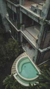 an overhead view of a swimming pool in a building at Proud Phu Fah Hip & Green Resort in Mae Rim