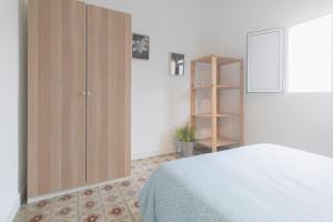 a bedroom with a bed and a wooden cabinet at La Monimba in Las Lagunas
