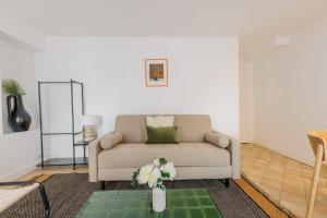 uma sala de estar com um sofá e uma mesa em Amazing and cosy apartment rue des Petites Ecuries 4P1BR em Paris