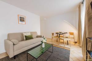 a living room with a couch and a table at Amazing and cosy apartment rue des Petites Ecuries 4P1BR in Paris