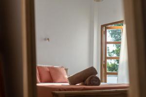 a living room with a couch and a window at NETS Cowork & Colive in Ahangama