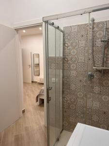 a bathroom with a shower with a glass door at Casa AnnaBella in Trapani