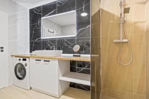 a bathroom with a sink and a washing machine at Park View in Oradea +7 photos