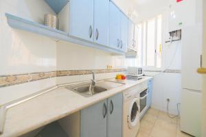 a white kitchen with a sink and a dishwasher at For You Rentals Encantadora vivienda de 3 habitaciones en Madrid AME49 in Madrid