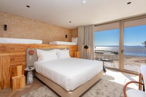 a bedroom with a large bed and a large window at Upon Vila - Alcochete Hotel in Alcochete