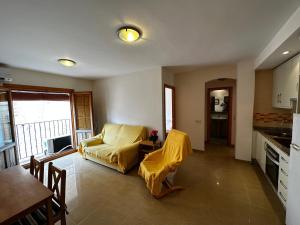 sala de estar con sofá amarillo y cocina en MU, Apartamento situada en la muralla del Casco Histórico en Villajoyosa
