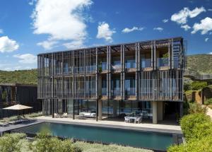 an external view of a building with a pool at Barbaros Reserve Bodrum Residences Managed by Kempinski in Bodrum City