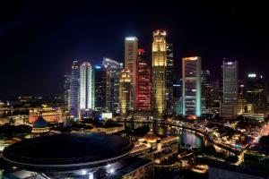 a view of a city at night with at Peninsula Excelsior Singapore, A Wyndham Hotel in Singapore