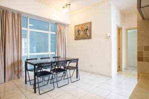 a dining room with a table and chairs and a window at Cosy 2Bed2Bathroom at Casa Suites in Petaling Jaya