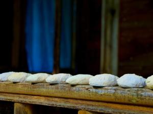 a group of loaves of bread on a wooden table at Zesopheli guest house in Keda Agro & Eco tourism in Zesop'eli