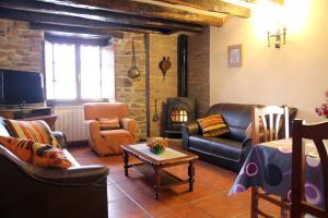 a living room with a couch and a fireplace at Casa Rural Gananea in Zuaztoy de Azpilcueta