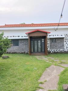 une maison en briques avec une porte dans une cour dans l'établissement Onsaemiro, à Seogwipo