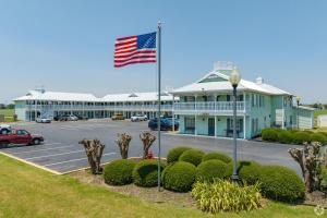 an american flag flying in front of a building at Key West Inn - Tunica Resort in Tunica Resorts