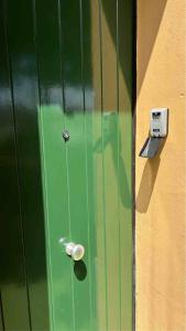 a green door with a lock on a wall at CORTICELLA 1 in Bologna