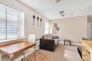 a living room with a table and a chair at Coach House - Lovely 1 Bedroom Flat near Derby City Centre in Derby