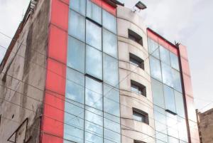 a tall building with red and blue windows at Hotel Novelty in Jammu