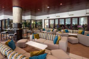 a lobby with couches and tables and windows at Savoy Beach Hotel & Thermal Spa in Bibione