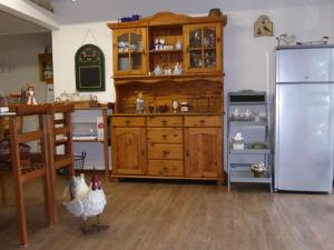 a kitchen with a large wooden cabinet and chickens in it at Spreewaldpension Beesk in Raddusch