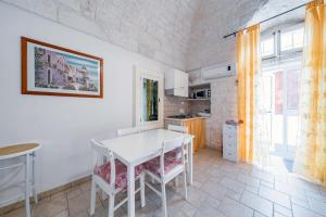 a kitchen with a white table and chairs at Salentina by Rentbeat in Ostuni
