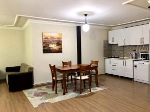 a kitchen and dining room with a table and chairs at Halic apart hotel in Yalova