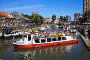 a boat filled with people on a river at Modern Studio & Apartment Roermond in Roermond +2 photos