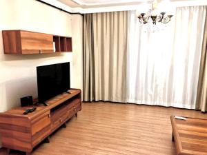 a living room with a flat screen tv and a large window at Halic apart hotel in Yalova