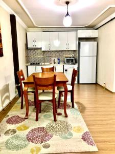 a kitchen with a wooden table and chairs in a room at Halic apart hotel in Yalova