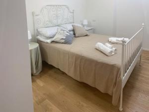 a bedroom with a white bed with towels on it at CamiLa's house in Milan