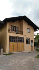 a house with two garage doors and a balcony at Bravo Guest House in Bihać