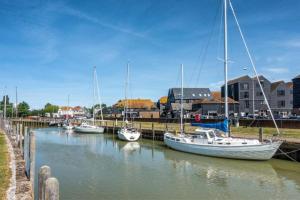 a group of boats are docked in a marina at Beachside Cottage - Camber Sands - Close to beach in Camber