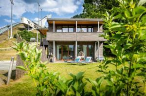 a house on a hill with two blue chairs at Partnachlodge in Garmisch-Partenkirchen