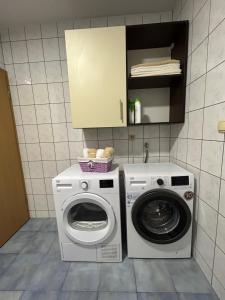 a kitchen with a washing machine and a washer at Apartman Milla in Ljubuški
