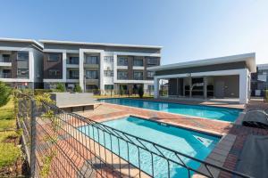 an image of a swimming pool in front of a building at One More Night Apartment E202 in Gaborone