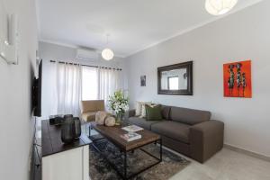 a living room with a couch and a table at One More Night Apartment E202 in Gaborone