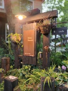 a wooden structure with potted plants in a garden at Hakuba Kaze no Ko in Hakuba