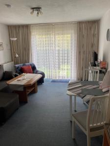 a living room with a couch and a table at von Wiegen, Ferienwohnungen in Schneverdingen