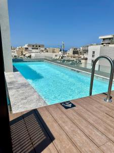 a swimming pool on the roof of a building at Eleven by Warren Collection in Sliema