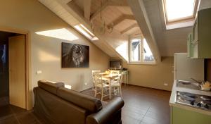 a living room with a couch and a table at Santa Giulia Hotel e Residence Torino in Turin