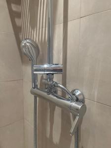 a shower stall with a chrome shower head in a bathroom at Apartment Castle Square z widokiem na Plac Zamkowy i Zamek Królewski in Warsaw +32 photos