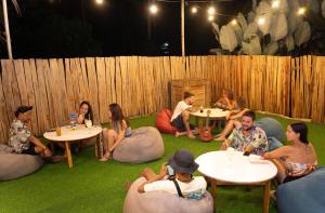 a group of people sitting in bean bags on the grass at My Green Hostel in San Vicente