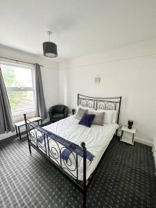 a bedroom with a bed and a chair and a window at Modern Town House - Coventry in Coventry