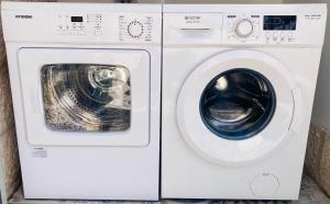 a washing machine and a dryer sitting next to each other at Lovely New Private Duplex in Prime City Center location in Jerusalem