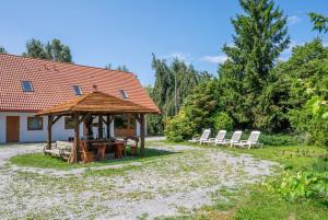 a group of chairs and a wooden gazebo at APARTAMENTY STODOŁA in Jezierzany