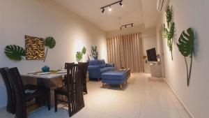 a living room with a table and a blue chair at Melaka Town/Sea View/10 min to Jonker/4-6Pax(2015) in Melaka