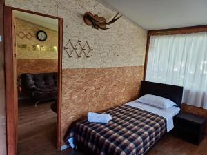 a small bedroom with a bed and a mirror at Blues Village in Lagodekhi