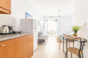 a kitchen with a refrigerator and a table with chairs at Urban Apt Next University 5 in Heraklio Town