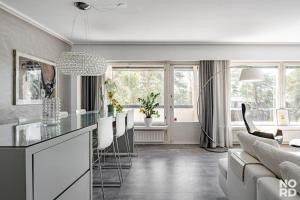 Westend Luxury Spa House في إسبو: مطبخ وغرفة معيشة مع أريكة وطاولة