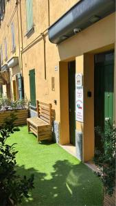 a wooden bench sitting outside of a building at CORTICELLA 1 in Bologna