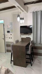a living room with a table and chairs and a television at CORTICELLA 1 in Bologna +23 photos