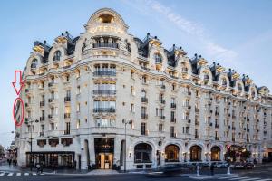 a large white building on the corner of a street at Exclusive Suite Parisian Palace in Paris